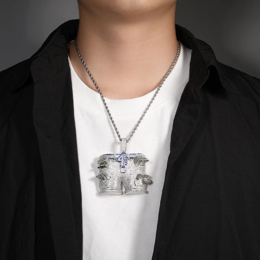 DatNewDrip iced out pants pendant on silver rope chain worn over white tee and black shirt