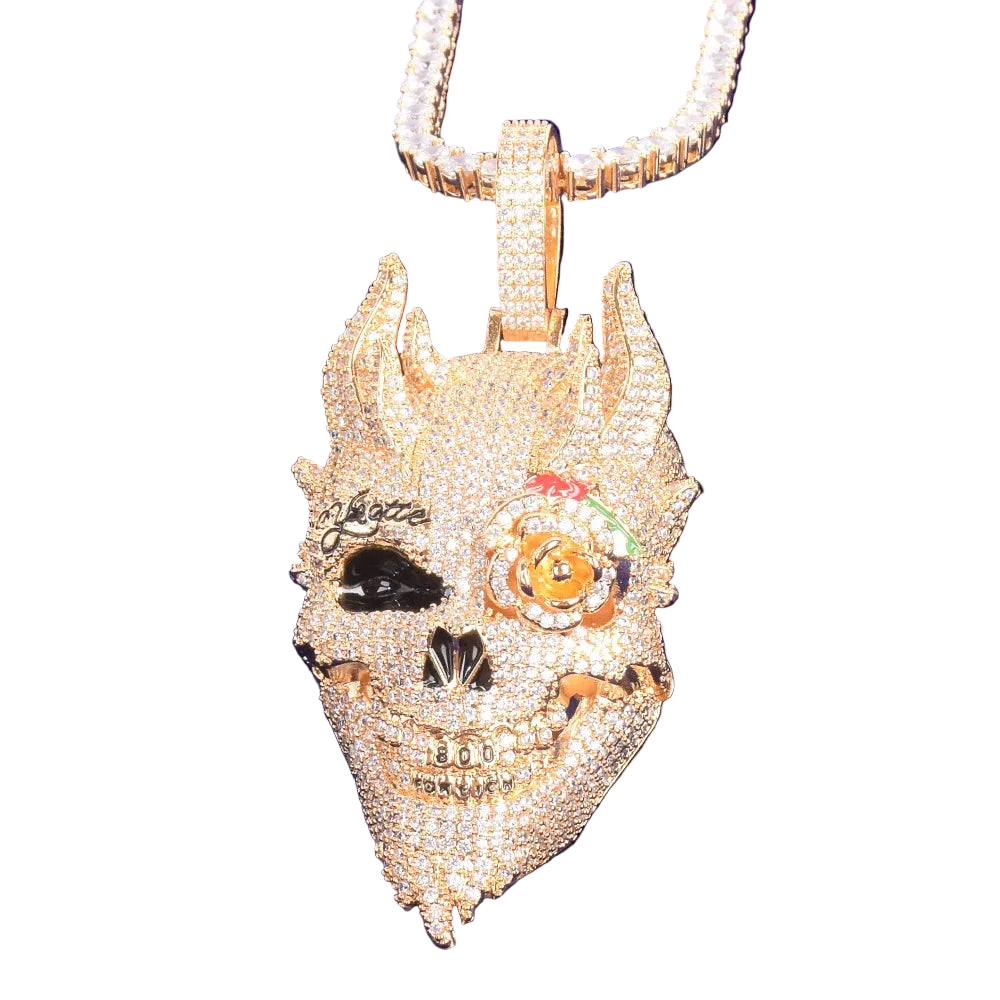 Gold pendant with intricate designs on a blue background