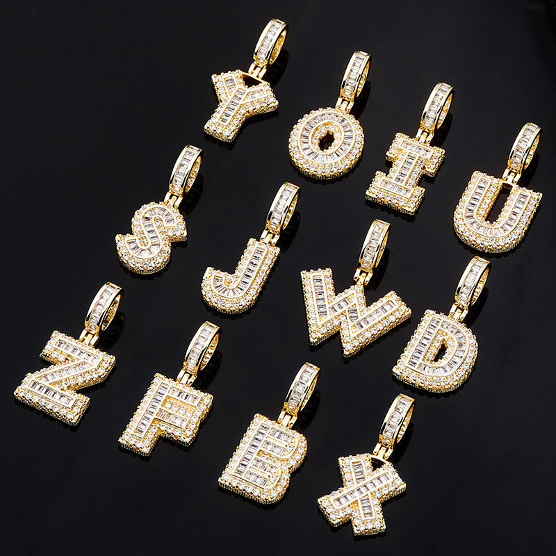 DatNewDrip iced out alphabet pendant collection gold letter charms encrusted with cubic zirconia on black