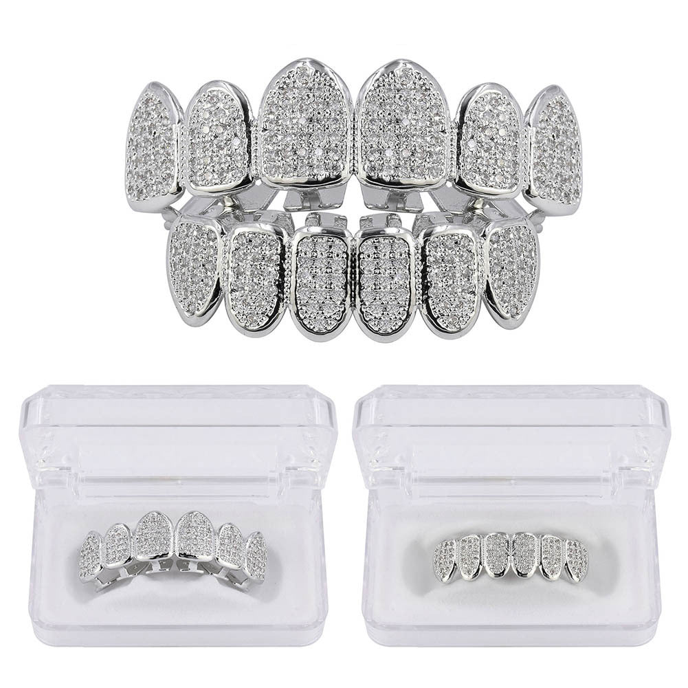 DatNewDrip silver tone full set iced out grillz with pave crystals top and bottom displayed in clear storage cases