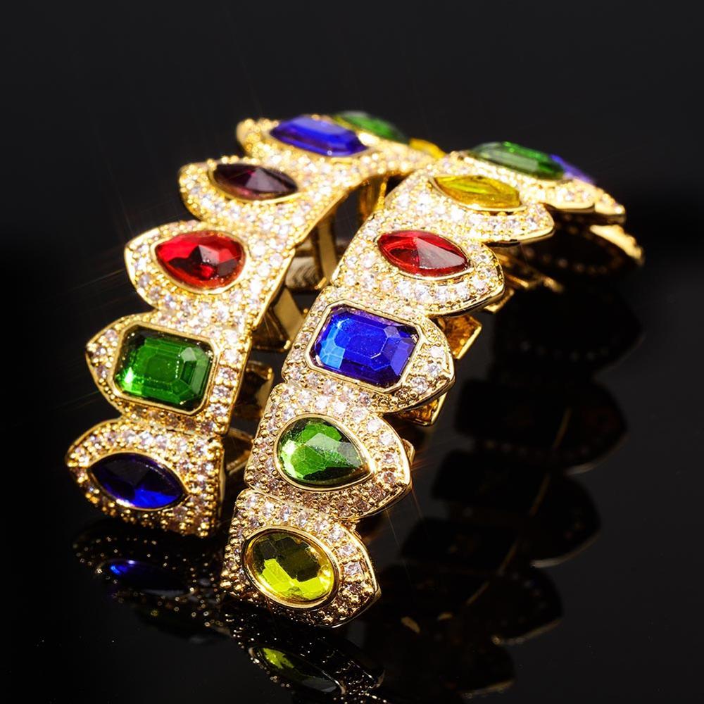 DatNewDrip gold dental jewelry with colored gem grillz featuring multicolor gemstones and pave diamonds
