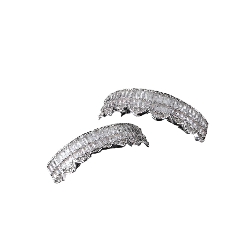 Silver two piece iced out baguette grillz with scalloped design and square baguette stones on top and bottom