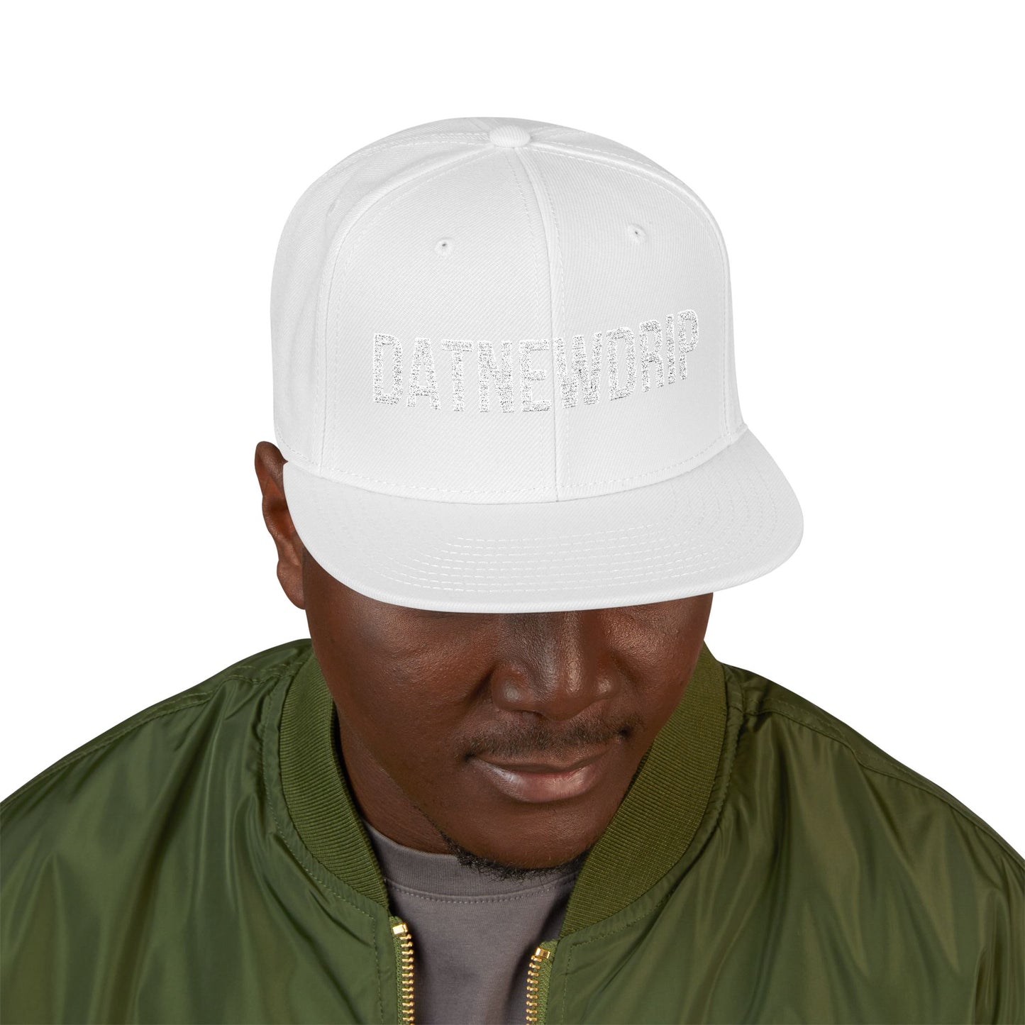 DatNewDrip white letter hip hop snapback hat worn by man with green jacket and gray shirt