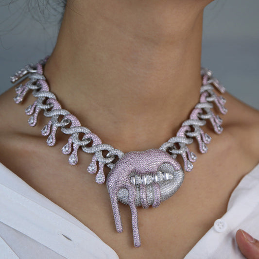 DatNewDrip Drooling Lips Necklace encrusted with pink and white crystals on model wearing white shirt
