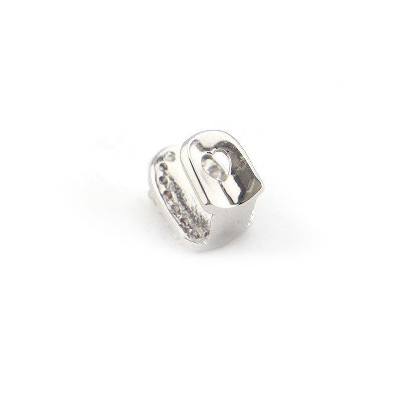 Polished silver single tooth cap with cubic zirconia accents and molded fit iced out single tooth grillz