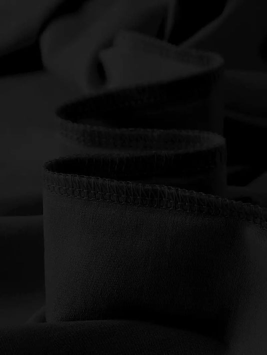 Close-up of a black Graphic Streetwear T-Shirt fabric showcasing soft texture and rolled hem