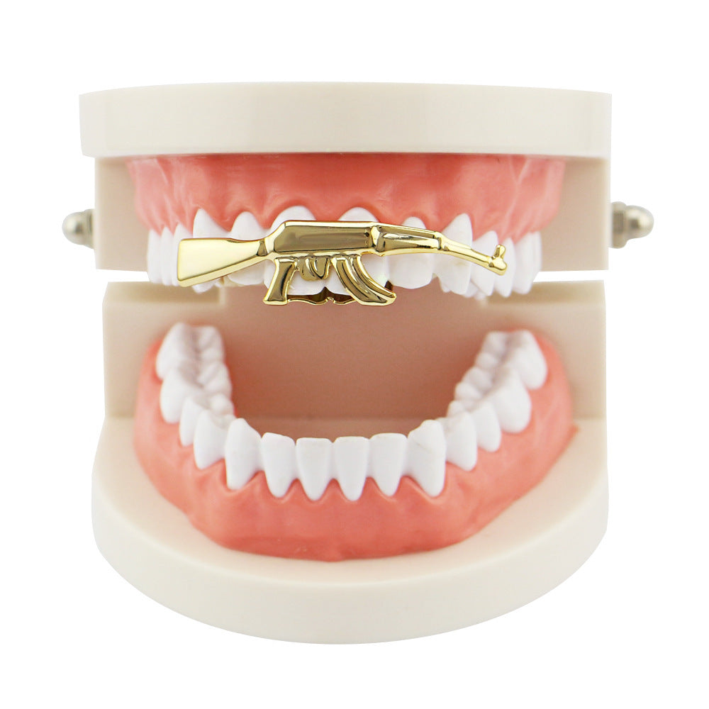 DatNewDrip gold AK47 grillz for teeth displayed on upper dental model as a single piece gold tooth accessory