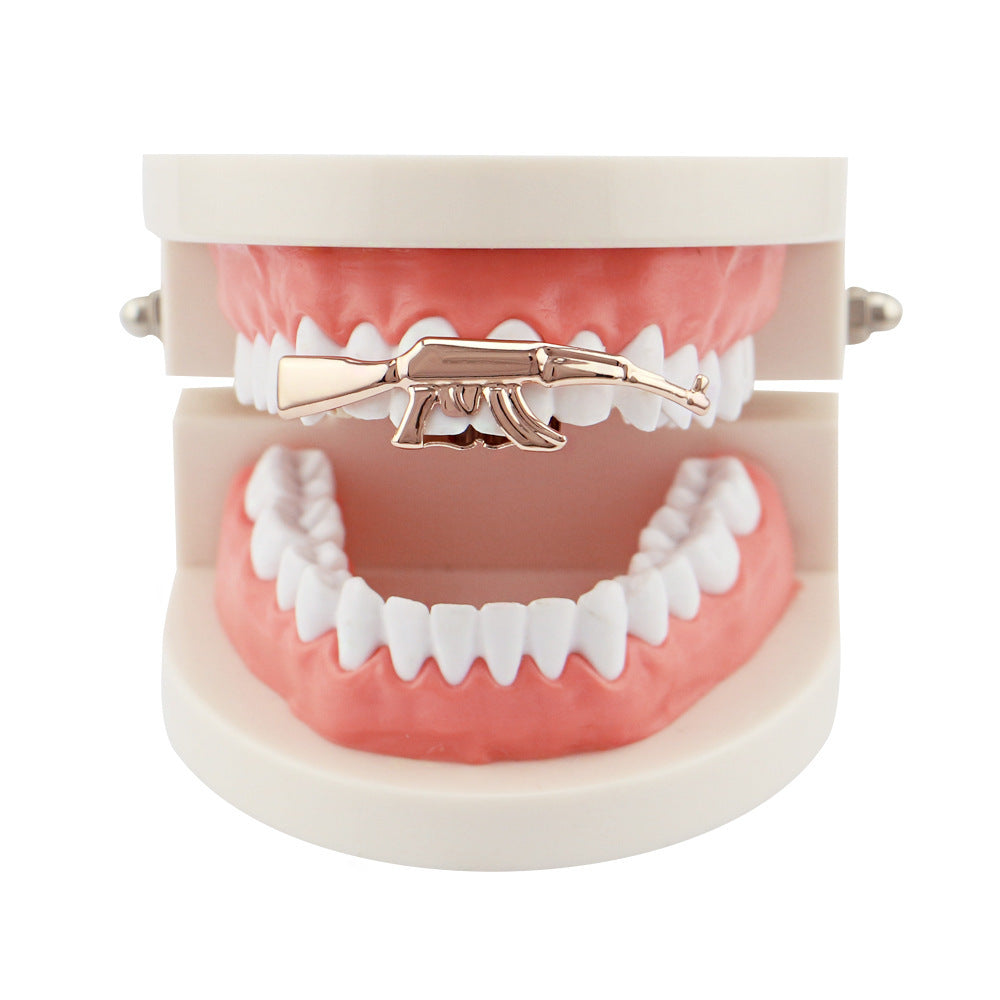 DatNewDrip gold AK47 grillz for teeth displayed on dental model upper teeth closeup