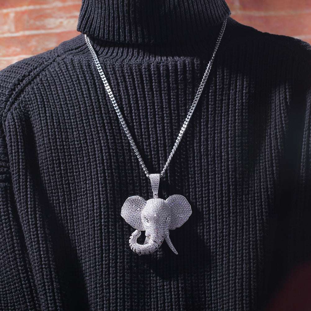 DatNewDrip iced out elephant pendant necklace worn over black ribbed sweater