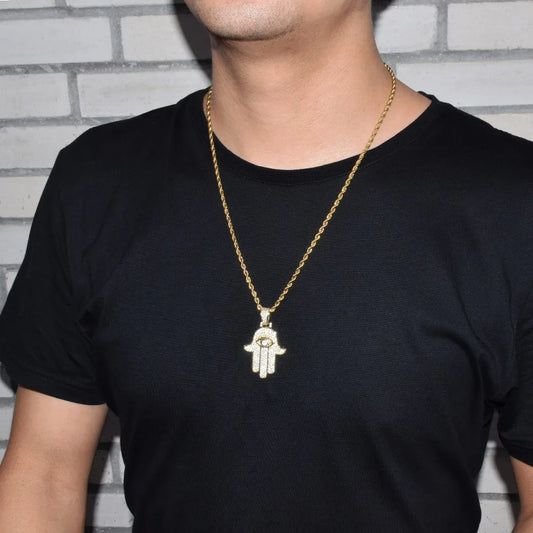 Gold iced out hamsa hand pendant necklace worn on a black t-shirt for stylish protection