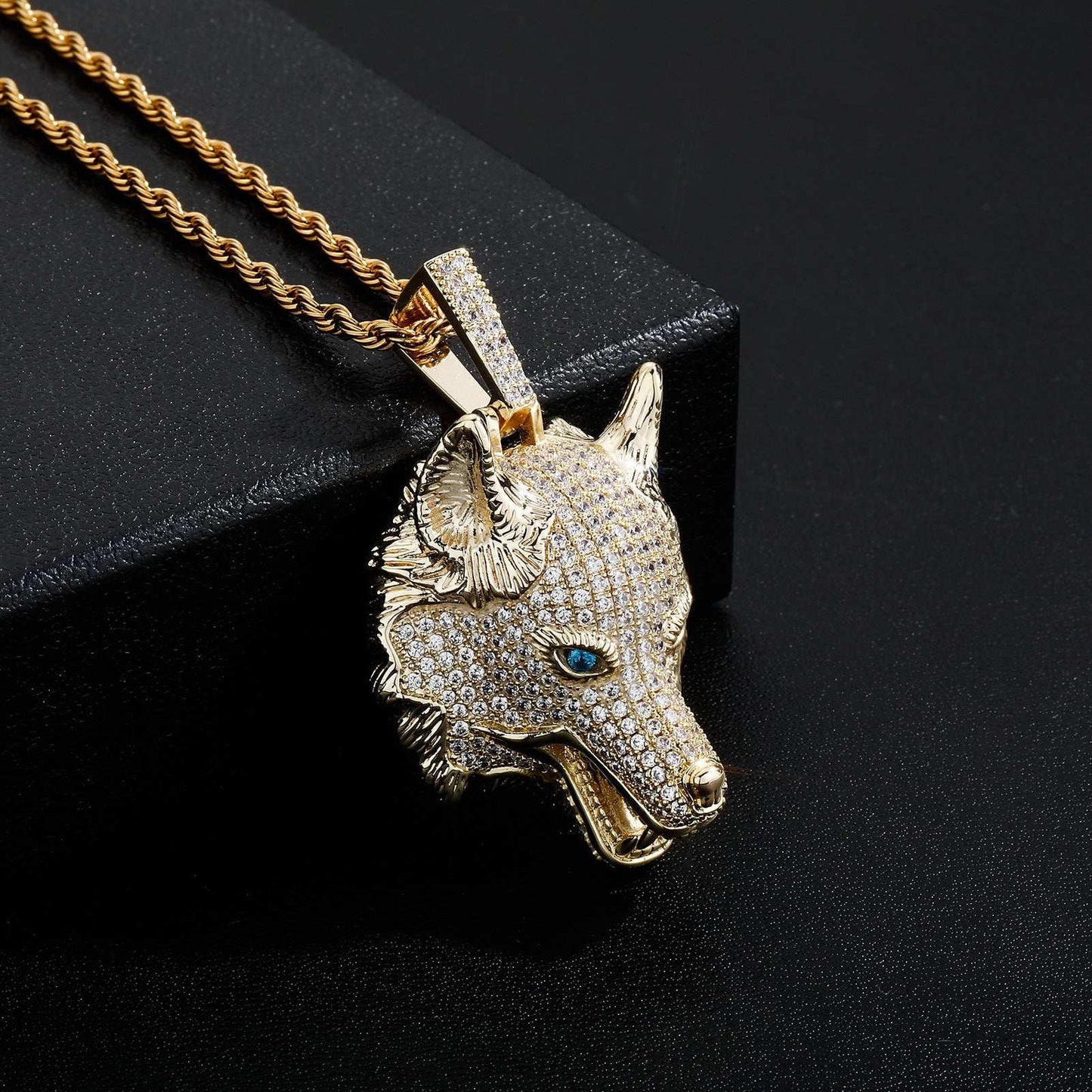 DatNewDrip iced out wolf pendant in gold with detailed blue eyes and sparkling stones on chain