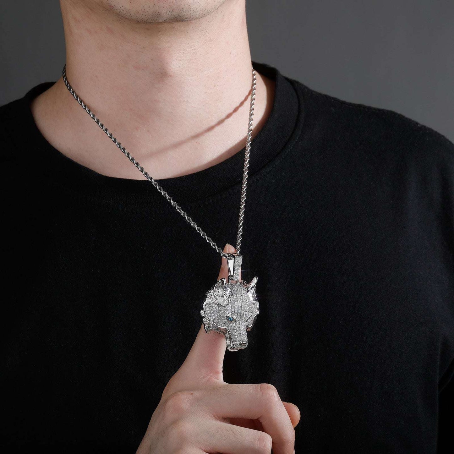 DatNewDrip iced out wolf pendant necklace worn on silver chain by man in black shirt