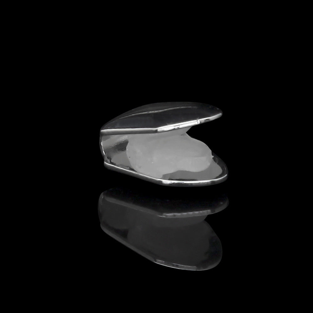 Polished silver single tooth grillz cap displayed open on black reflective background