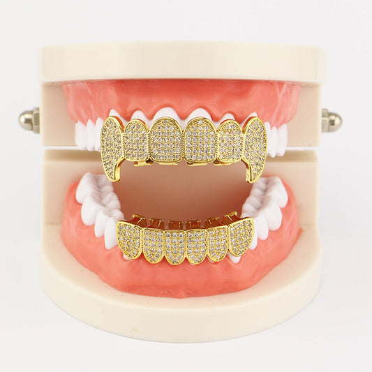 DatNewDrip iced out vampire fang grillz gold pave top and bottom fang set shown on dental display model