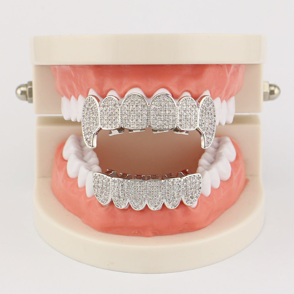 DatNewDrip iced out vampire fang grillz displayed on dental model silver cubic zirconia encrusted fangs