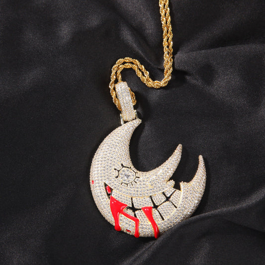 DatNewDrip iced out trippie red moon pendant on gold rope chain encrusted with cubic zirconia and red drip detail
