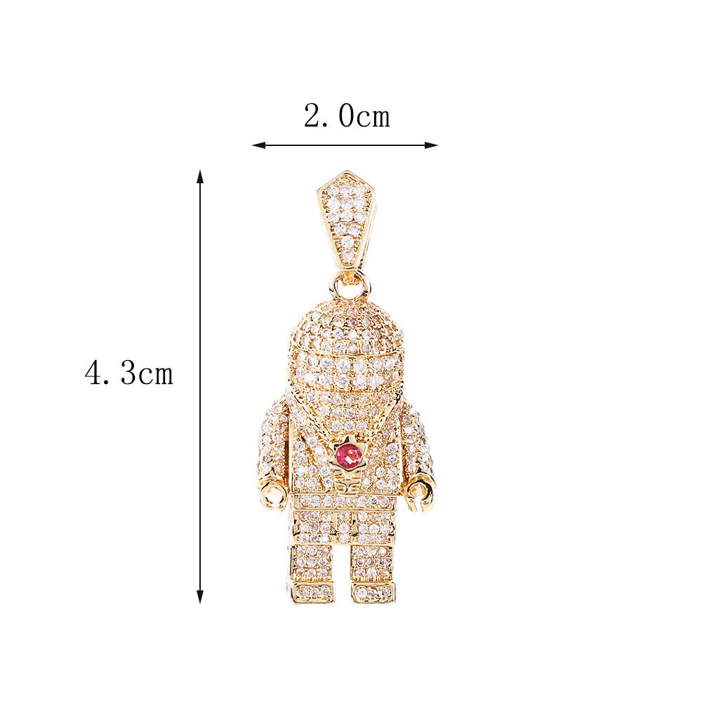 DatNewDrip iced out spaceman pendant gold astronaut jewelry encrusted with clear crystals and red chest gem 4.3 cm by 2.0 cm