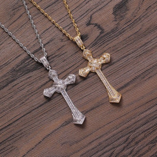 DatNewDrip iced out cross pendant pair in gold and silver with rope chains on wood background