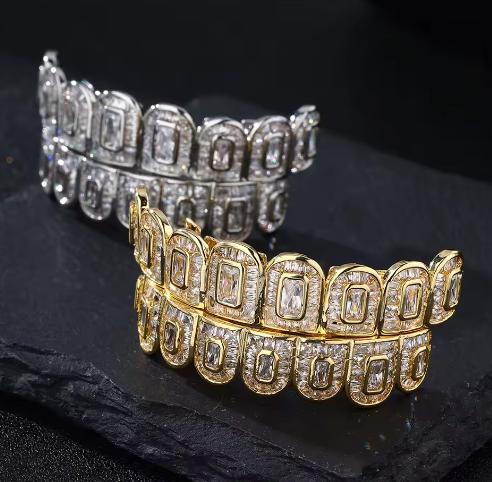 Collection of custom gold and diamond iced out grillz with bold designs including blue BOSS letters