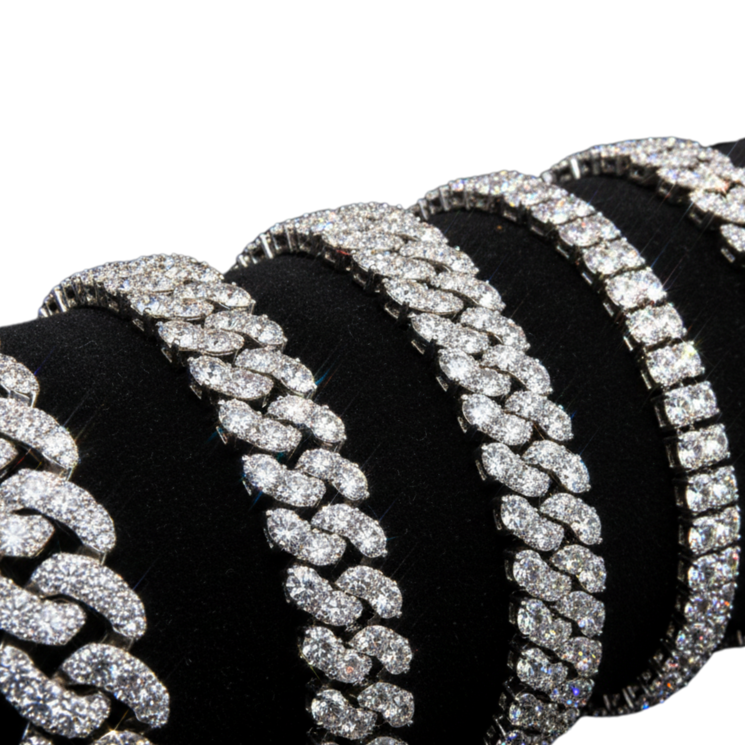 Bling bracelets hip hop style in gold with diamonds and blue gemstones arranged on reflective surface