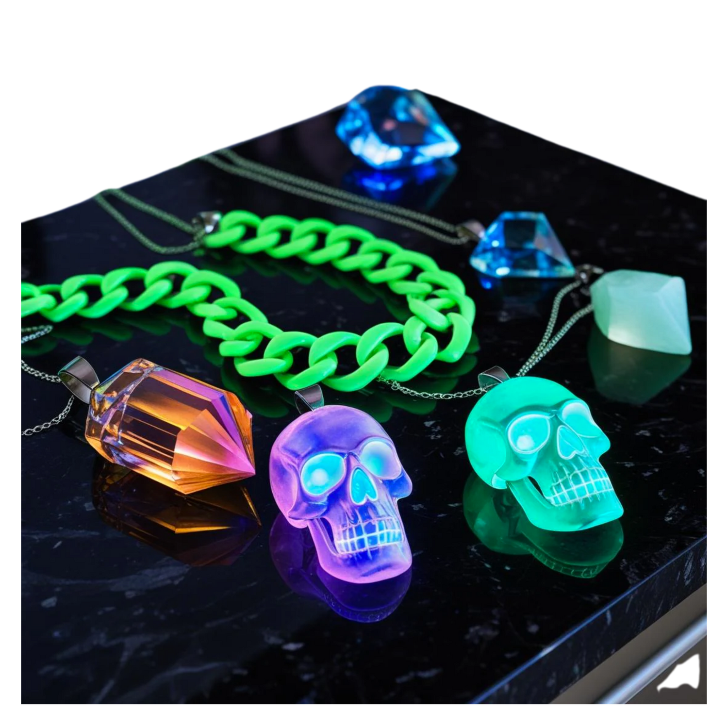 Luminous Jewelry collection featuring gold chains with skull and cross pendants and matching gemstone rings