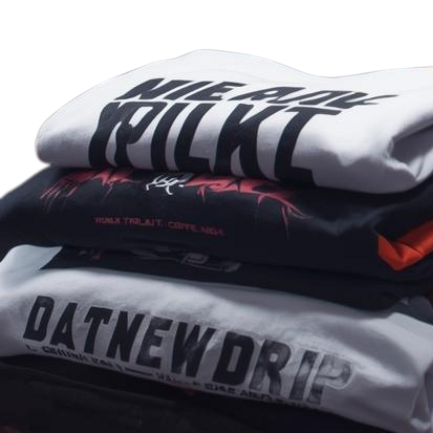 Stack of stylish graphic tees featuring skulls and crowns with graffiti backdrop