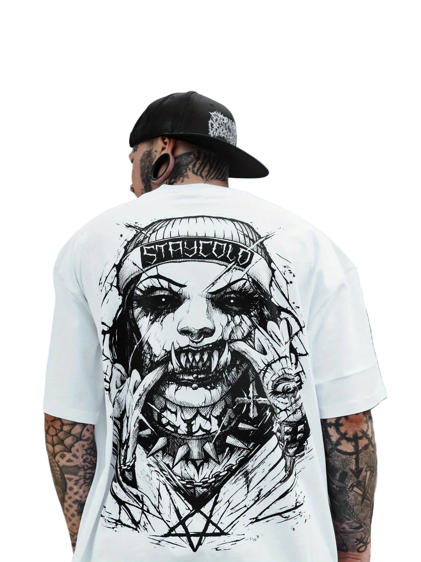 Person wearing a white t-shirt with a black graphic design on the back, standing outdoors.