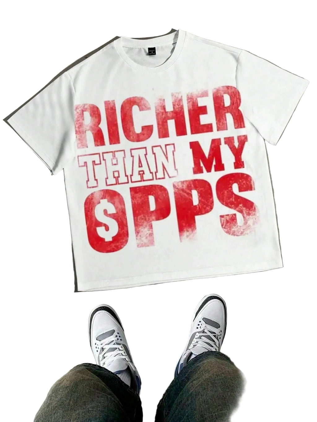 White t-shirt with red text 'RICHER THAN MY $PPS' on a concrete floor.