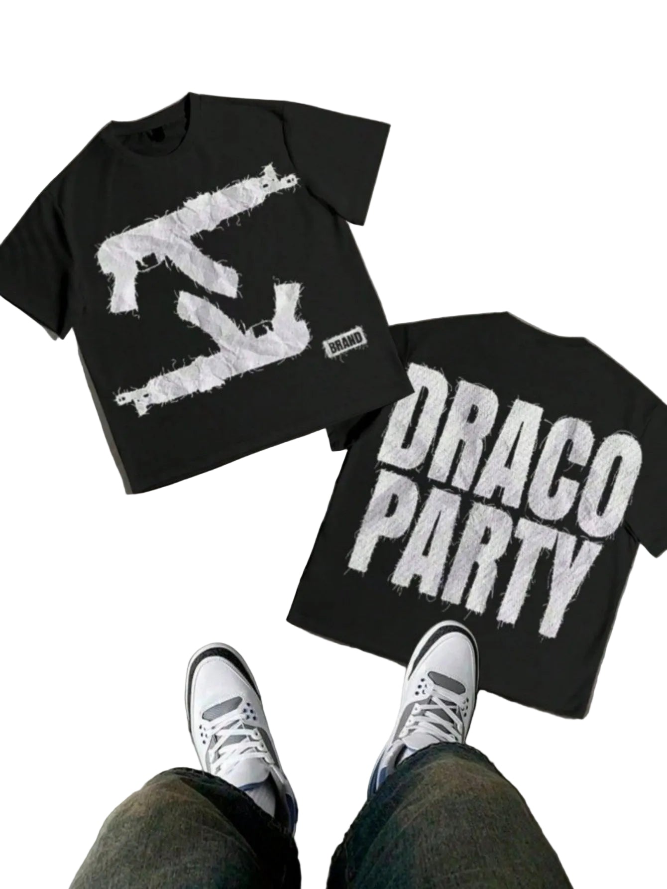 Two black t-shirts with white graphics and text on a concrete floor.