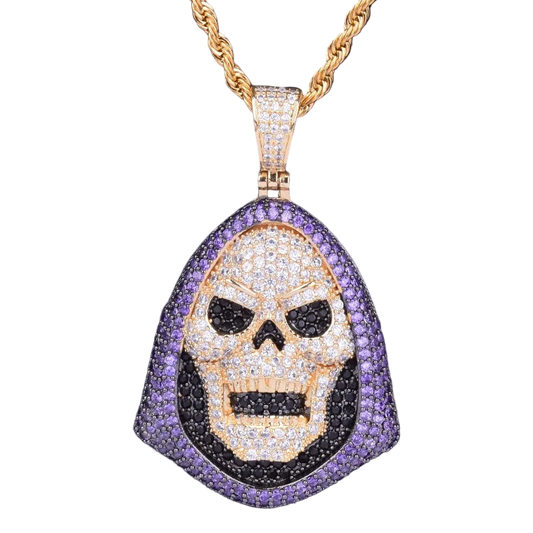 Skull pendant necklace with gold chain on a dark background