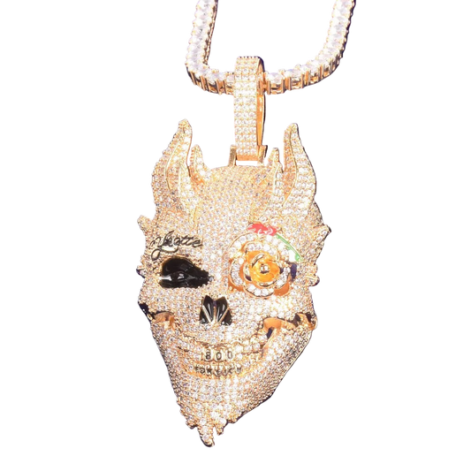 Gold pendant with intricate designs on a blue background