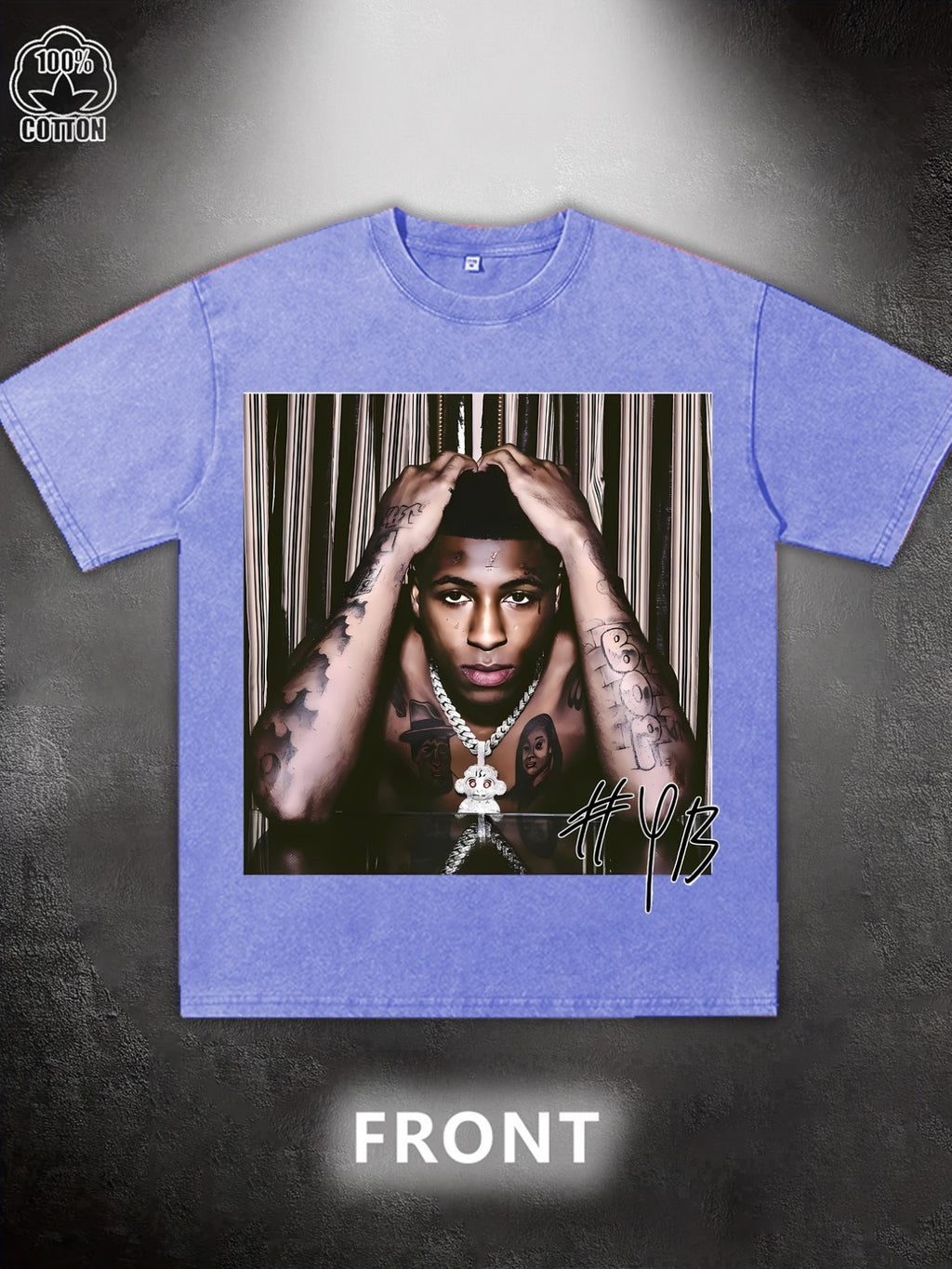 Blue t-shirt with a graphic of a person with tattoos and a necklace on a dark background.