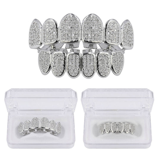 DatNewDrip silver tone full set iced out grillz with pave crystals top and bottom displayed in clear storage cases