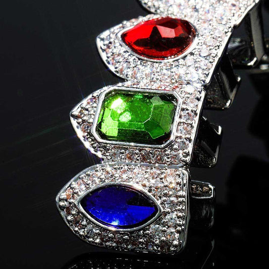 DatNewDrip colored gem grillz close up silver tooth caps with red green and blue gems and clear pave stones