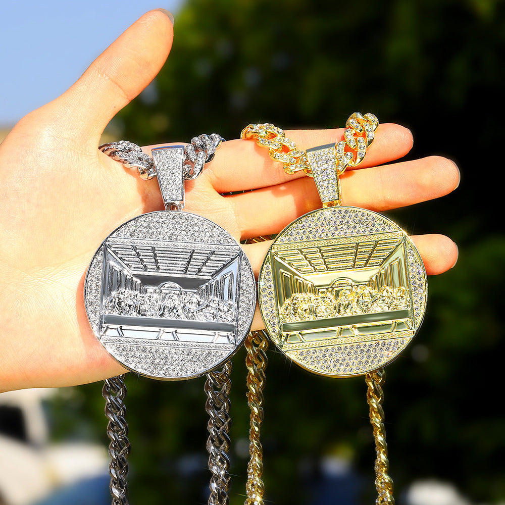 DatNewDrip iced out last supper pendant in silver and gold on thick Cuban chains held in hand