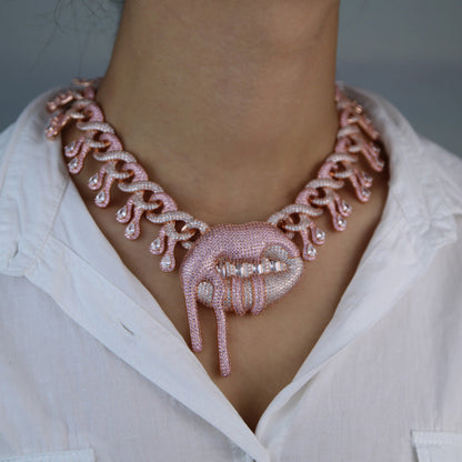 DatNewDrip Drooling Lips Necklace in rose gold with intricate dripping lip design worn on white shirt