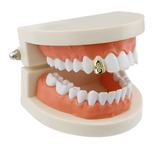 Dental model with diamond cross hip hop tooth grill on upper front tooth gold single tooth display