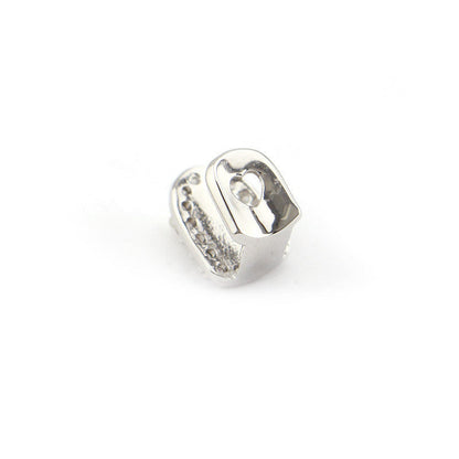 Polished silver single tooth cap with cubic zirconia accents and molded fit iced out single tooth grillz