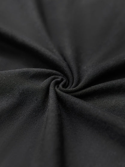 Close-up of soft black fabric showcasing the material quality of a graphic streetwear t-shirt