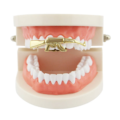 DatNewDrip gold AK47 grillz for teeth displayed on upper dental model as a single piece gold tooth accessory