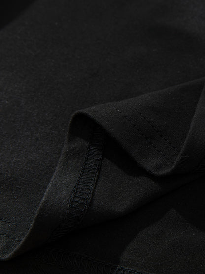 Close-up of a black graphic streetwear t-shirt showcasing premium fabric texture and stitching details