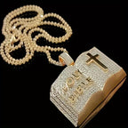 Gold iced out bible pendant with detailed lettering and cross on a matching chain