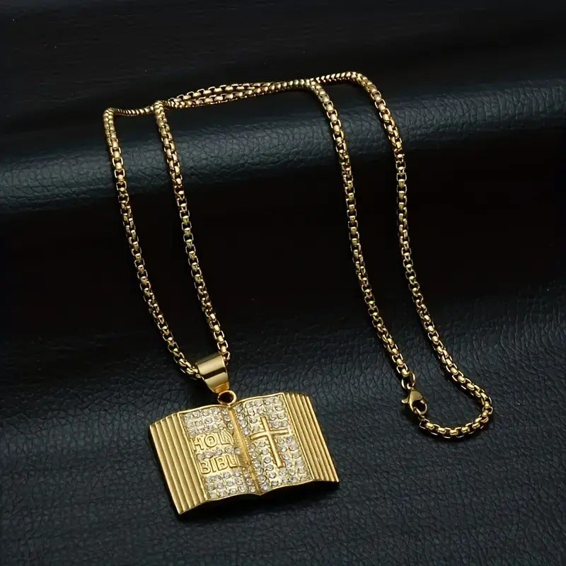 Gold iced out bible pendant with detailed engraving on a matching chain necklace
