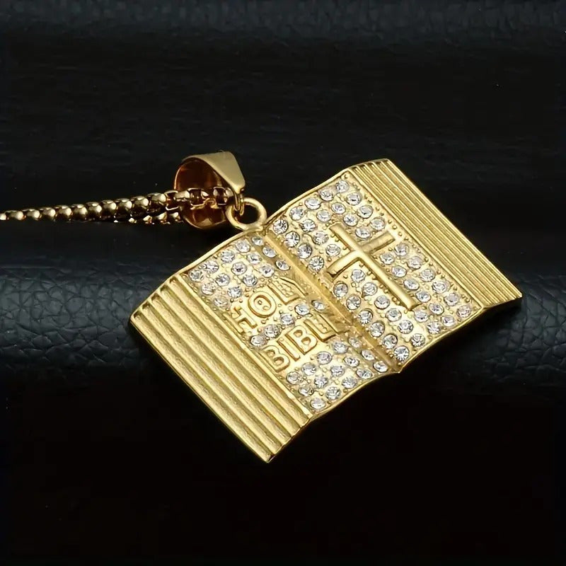 Gold iced out bible pendant adorned with sparkling rhinestones and a cross detail