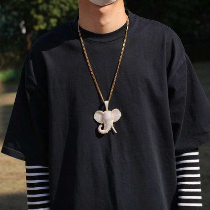 DatNewDrip iced out elephant pendant on a gold chain worn with a black shirt and striped sleeves