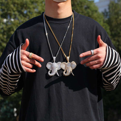 DatNewDrip iced out elephant pendant necklaces in silver and gold worn on black shirt with striped sleeves
