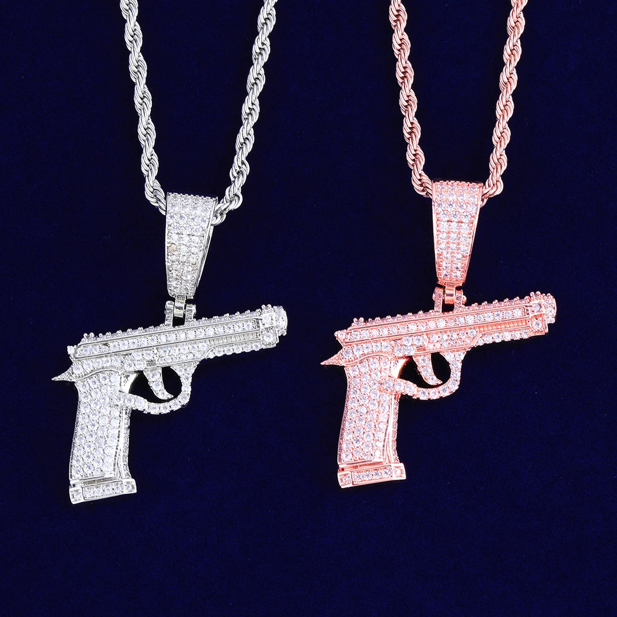 Iced out gun necklace in silver and rose gold options with sparkling diamond-like embellishments