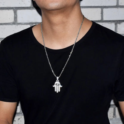 Stylish iced out hamsa hand pendant necklace on a model, perfect for any casual outfit