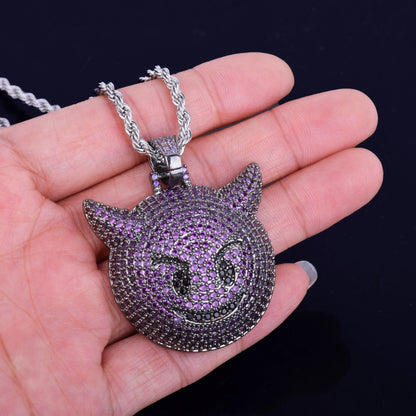 Iced Out purple demon pendant necklace with intricate purple and silver detailing held in hand