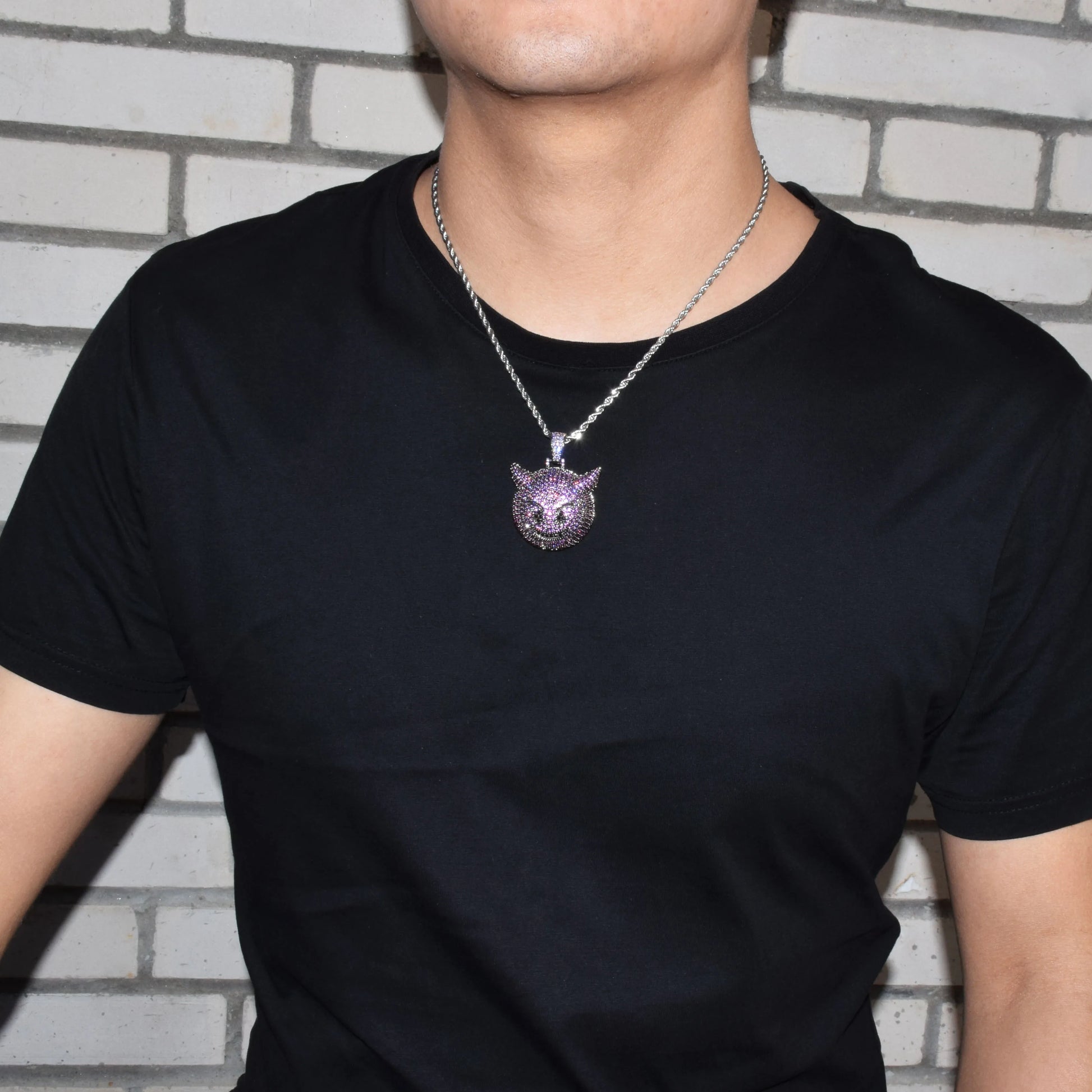 Iced Out purple demon pendant necklace showcased on a model wearing a black t-shirt